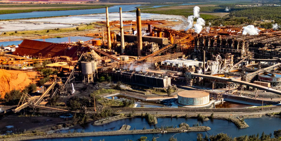 Gladstone industrial works seen from above, red ochre earth and tidal waterways around it.