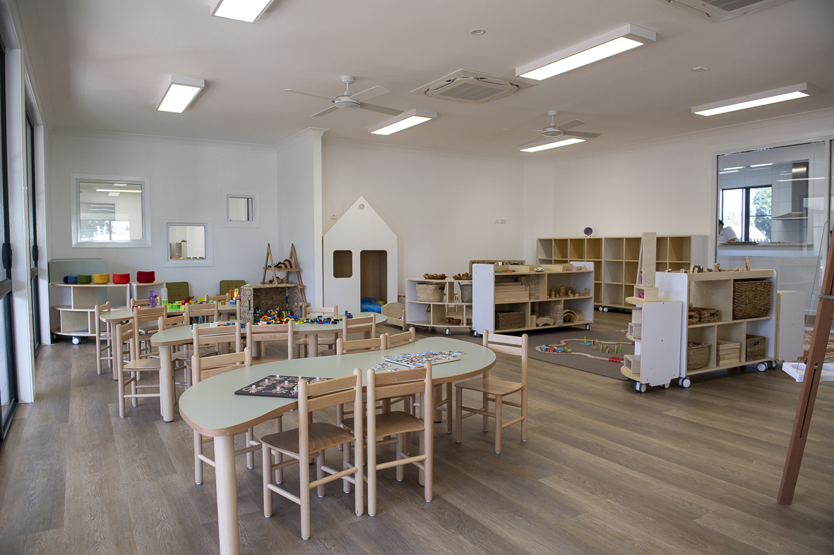 A First5Years Emerald learning environment: timber furniture, green tables and natural light.