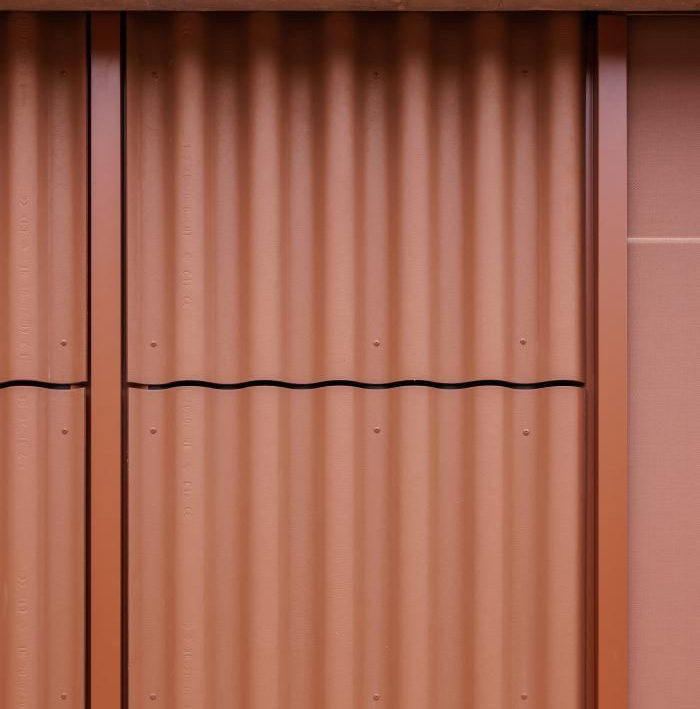 Reference image: reddish-brown corrugated metal cladding.